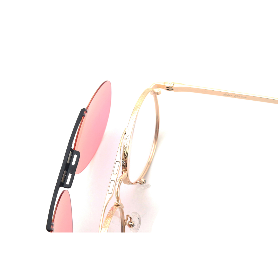 Sunglasses with gold frame and pink lenses on a white background